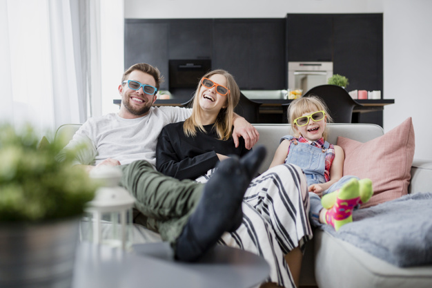 cheerful-family-watching-film-couch_23-2147800090